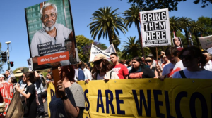 From the cover of the Amnesty report: People march to demand humane treatment of asylum seekers and refugees, in Sydney, November 5, 2016. Photo: Peter Parks/AFP/Getty Images