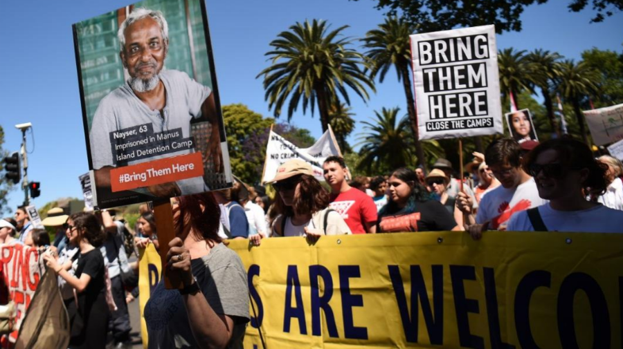 From the cover of the Amnesty report: People march to demand humane treatment of asylum seekers and refugees, in Sydney, November 5, 2016. Photo: Peter Parks/AFP/Getty Images