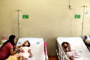 A woman comforts her daughter, who is recuperating from dengue fever, in a hospital in Manila, Philippines, August 23, 2019. REUTERS/Eloisa Lopez