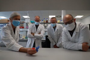 Belgium scientists show an enlarged 3D model of a spike protein (blue) connected to an antibody (red)